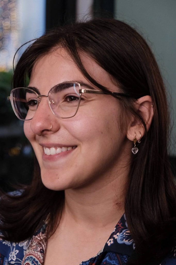 Client with healed nose and ear piercings smiling