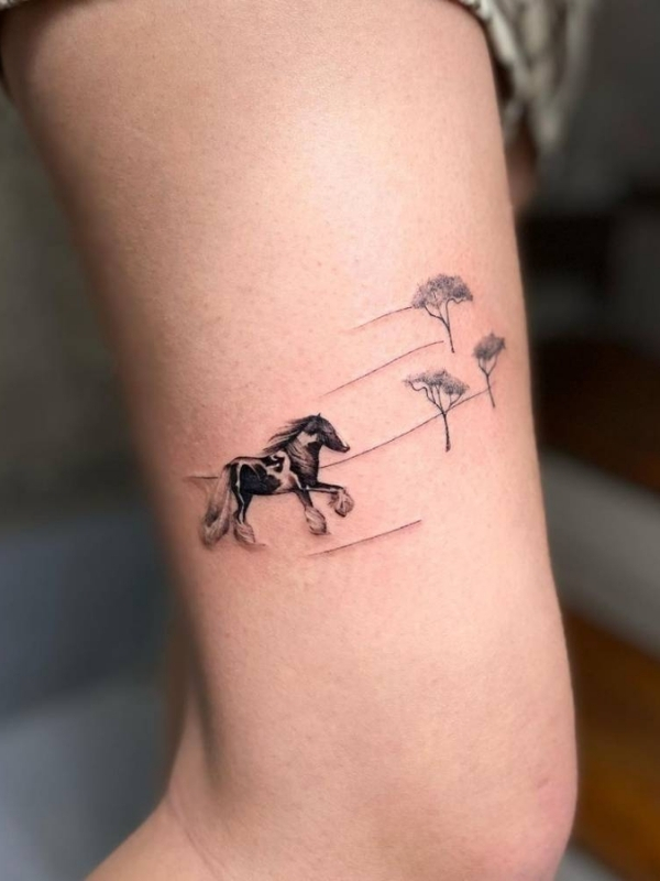 Mini horse tattoo on bicep