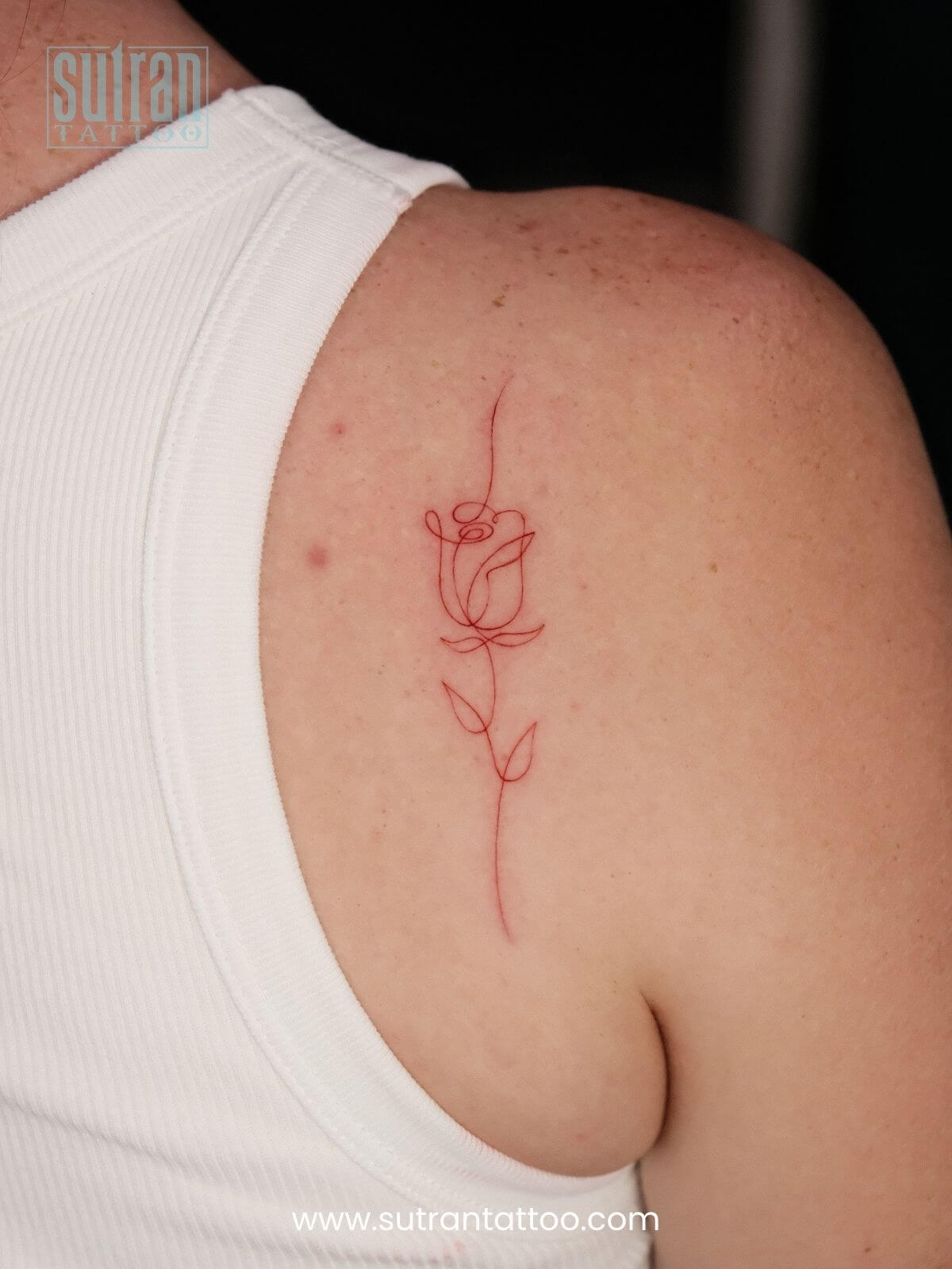 Rose tattoo on shoulder