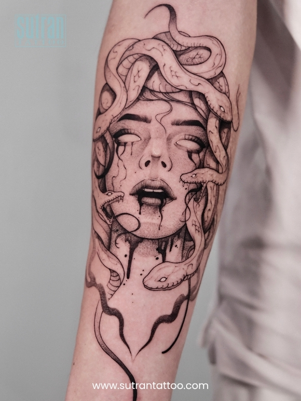 Tattoo artist working on a small design in a Ho Chi Minh City studio