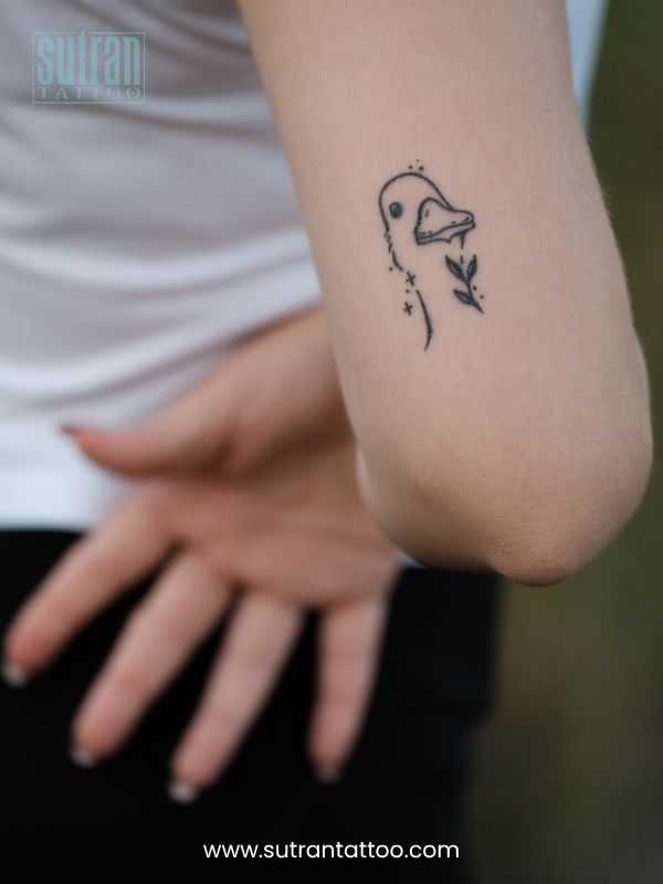 Applying a thin layer of fragrance-free moisturizer to healing tattooed skin