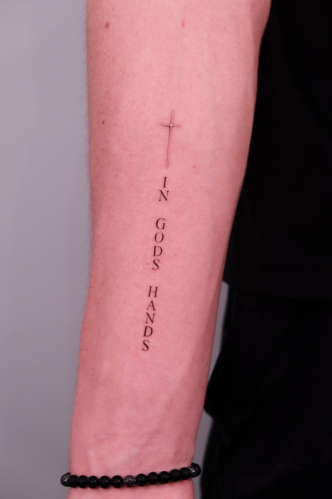 Fine Line Cross Lettering Tattoo on Forearm