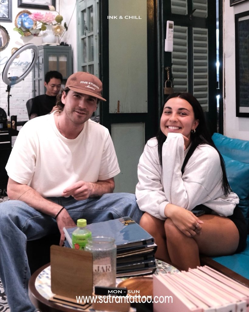 Tattoo consultation between artist and client at a studio in Ho Chi Minh City
