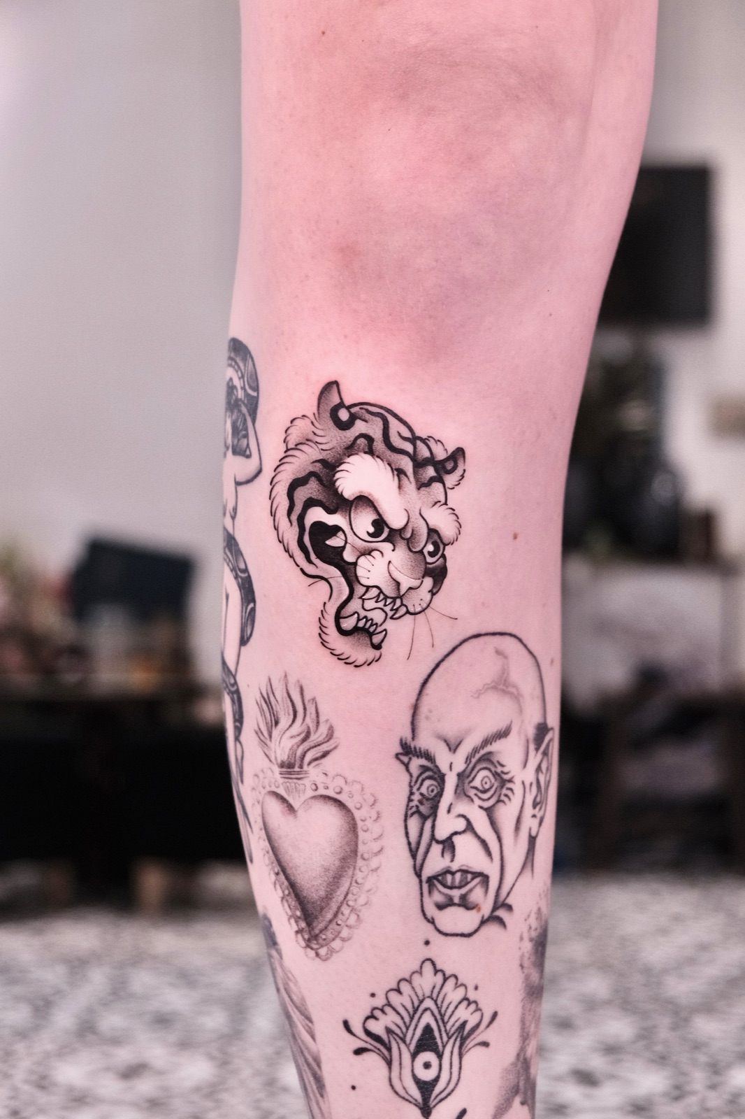 Neo-traditional tiger head tattoo with bold color shading on the calf