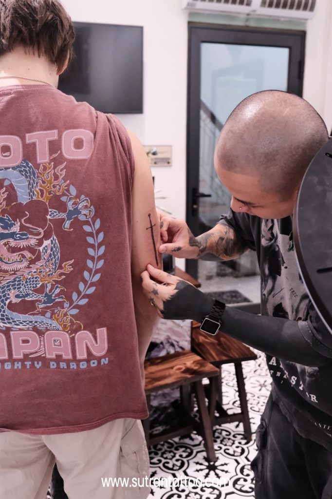 Artist refining the design with the client before a first tattoo session
