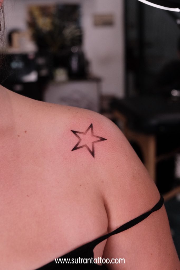 How much a tattoo hurts depends on placement - small star tattoo on the shoulder, a low-pain area
