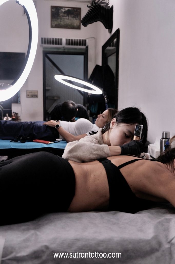 A comfortable lying position helps reduce tattoo pain during the session