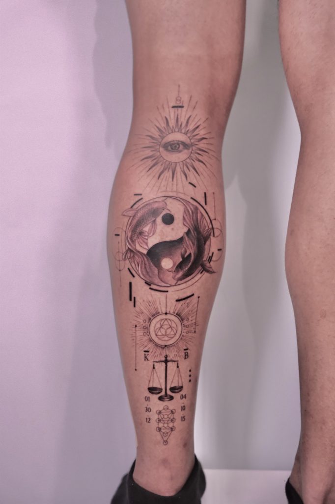 Fine-line sun, moon and yin-yang design on the calf